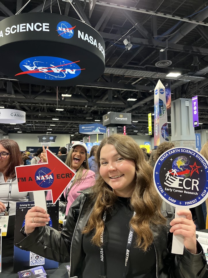 Gabriella Zuccolotto holding signs for NASA ECR