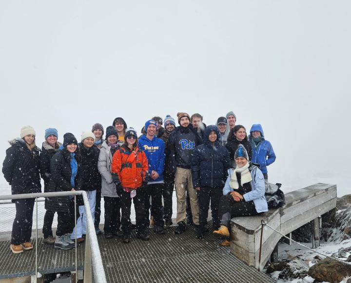 Groups of students standing in the snow.