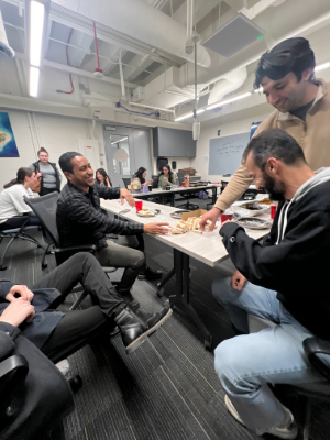 Students smile while they play a table game.