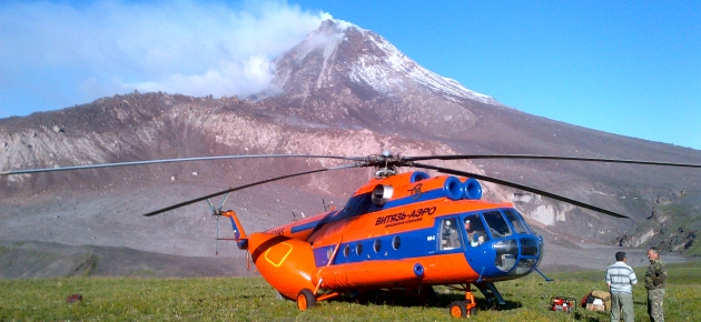 Helicopter grounded in front of Kizimen Volcano