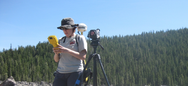 A female student conducting a GPS survey at Medical Lakes Dome, CA