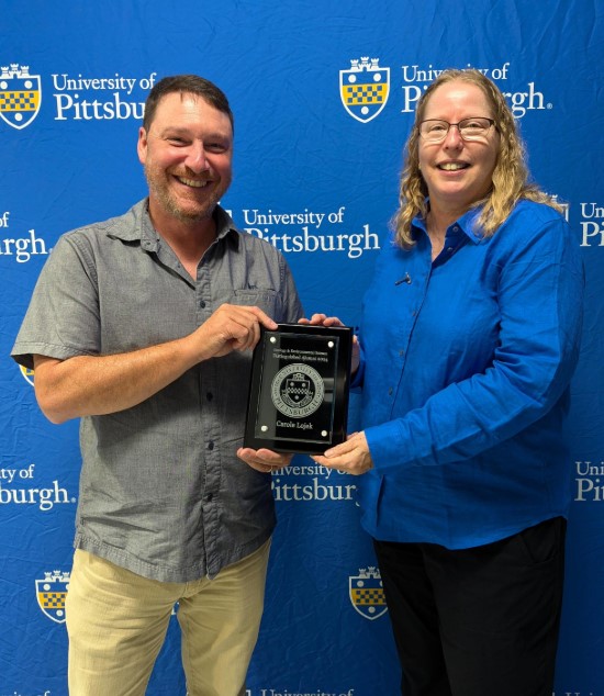 Carole Lojek receiving the Distinguised Alumni award