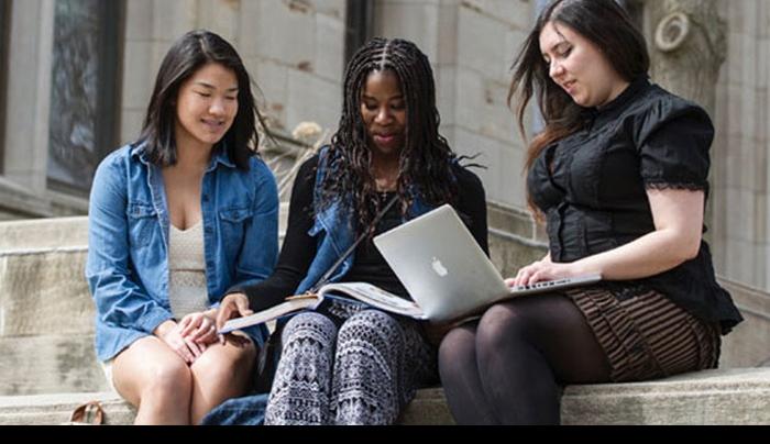 Students doing homework on a set of exterior stairs