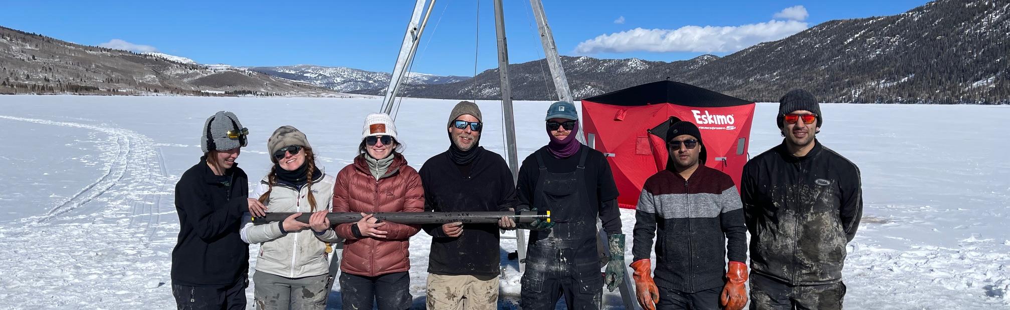 Group of faculty and students on frozen lake.