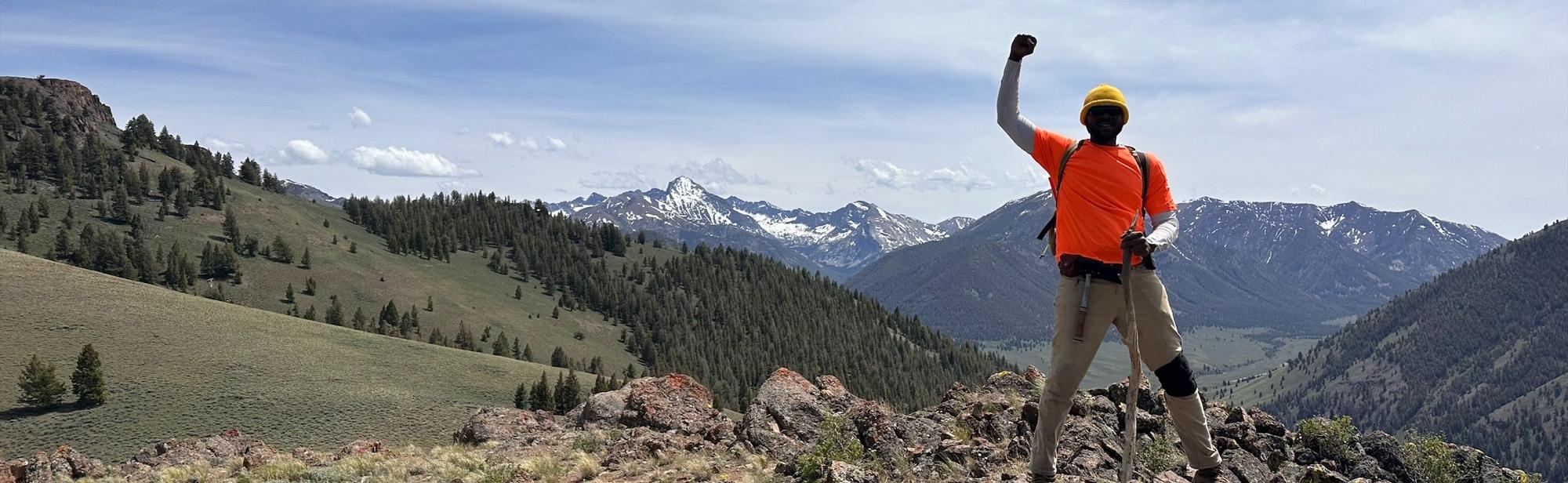 Student at top of mountain.